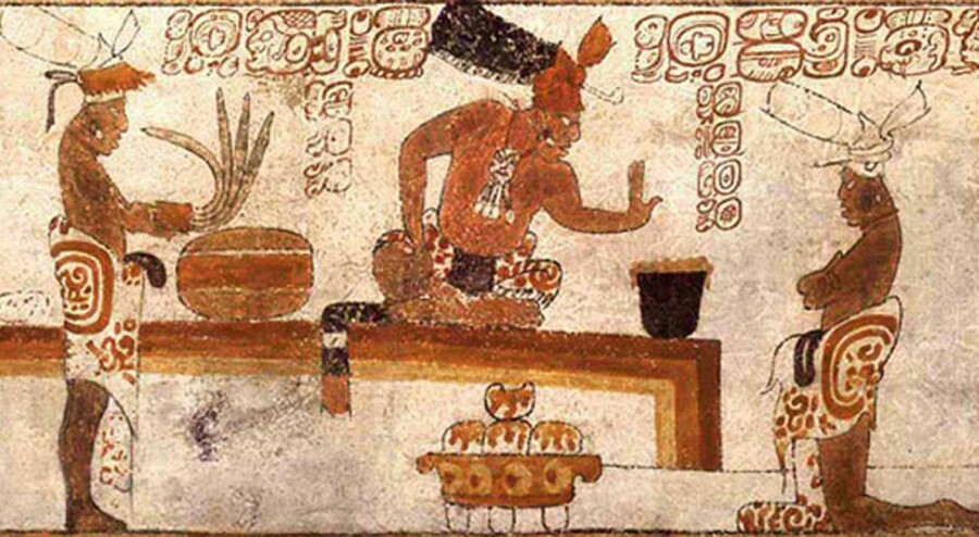 Ancient Mesoamerican cacao ceremony illustration showing figures in traditional attire preparing and sharing a cacao drink during a ritual.